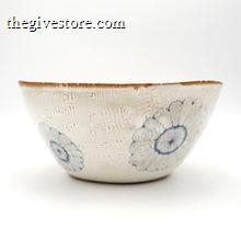 Ceramic bowl with blue floral patterns on a white background