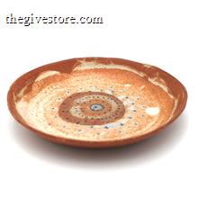 Ceramic plate with a decorative spiral pattern on a white background