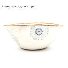White ceramic bowl with floral design on a white background
