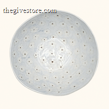 Round ceramic bowl with floral pattern on a white background