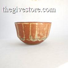 Ceramic bowl with brown and green glaze on a white background