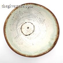 Ceramic bowl with a textured surface on a white background