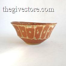 Ceramic bowl with brown and green glaze on a white background