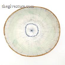 Round ceramic bowl with a textured surface on a white background