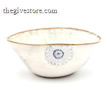 White ceramic bowl with brown rim and blue floral design on a white background