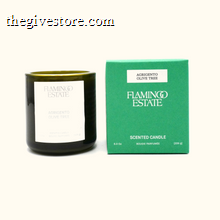 Black candle with white label and green box labeled 'Flamingo Estate' on a white background