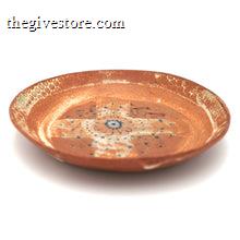 Ceramic plate with decorative patterns on a white background