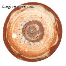 Round ceramic plate with concentric circle pattern on a white background