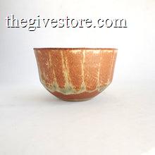 Ceramic bowl with a textured brown and green surface on a white background