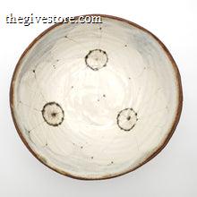 Ceramic bowl with circular patterns on a white background
