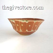 Ceramic bowl with brown and green glaze on a white background