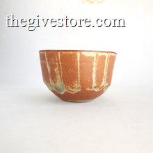 Ceramic bowl with brown and green glaze on a white background