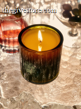 Flamingo Estate Night Blooming Jasmine & Damask Rose candle with label burning with cocktail offerings