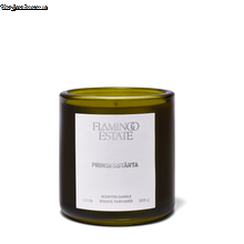 Green candle with a white label on a white background