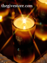 Flamingo Estate candle flame in green glass holder.